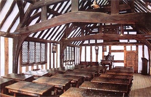 interior of an Elizabethan classroom with small wooden desk