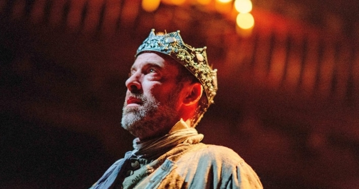 king macbeth stands under candles