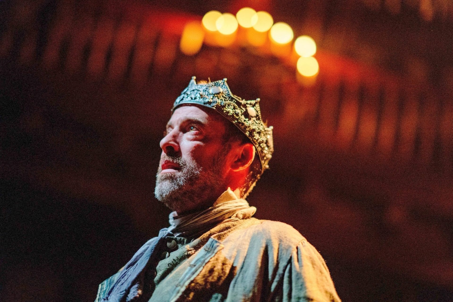king macbeth stands under candles