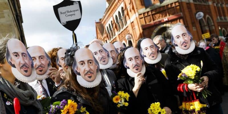 Crowds wearing Shakespeare masks during the Shakespeare Birthday Celebrations procession