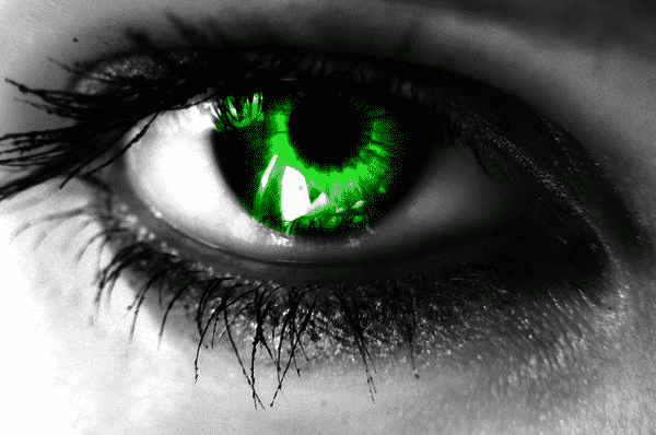 a green eye on black and white close up of an eye, representing the green-eyed monster